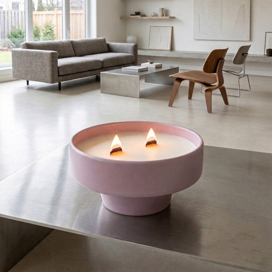 PRESENTE Taller Artesanal pastel pink ceramic double wick candle with pedestal base, burning.